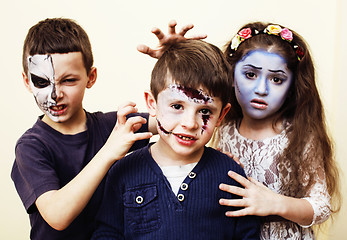 Image showing zombie apocalypse real kids concept. Birthday party celebration facepaint on children dead bride, scar face, zombie skeleton together close up makeup emotional posing.