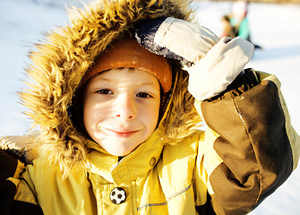 Image showing little cute boy in hood with fur on snow outside