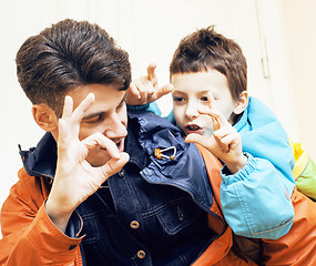 Image showing young handsome father with his son fooling around at home, lifes