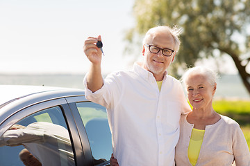 Image showing happy senior couple with car key at seaside