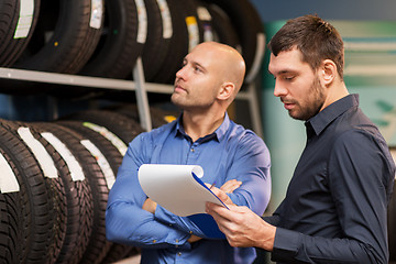 Image showing customer and salesman at car service or auto store
