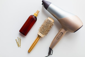 Image showing hairdryer, brush, hot styling hair spray and pins