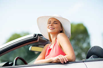 Image showing happy young woman in convertible car