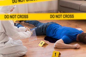 Image showing criminalist collecting evidence at crime scene