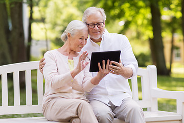 Image showing senior couple with video chat on tablet pc at park