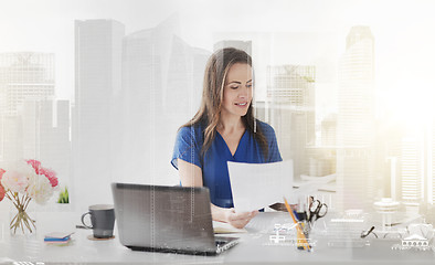 Image showing happy woman with papers and laptop at office