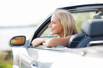 Image showing happy young woman in convertible car