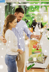 Image showing happy couple weighing cabbage on scale at grocery