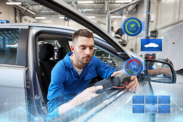 Image showing mechanic man with diagnostic scanner at car shop