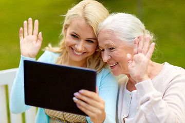 Image showing daughter with tablet pc and senior mother at park