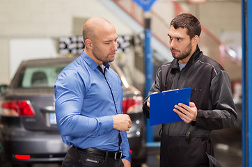 Image showing auto mechanic and customer at car shop