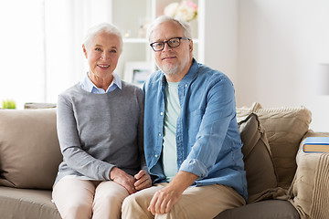 Image showing happy senior couple sitting on sofa at home