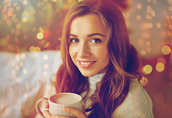 Image showing happy woman drinking cocoa at home for christmas