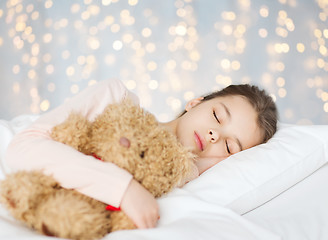 Image showing girl sleeping with teddy bear toy in bed