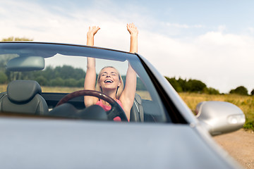 Image showing happy young woman in convertible car