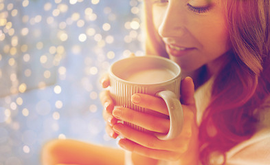 Image showing close up of happy woman with cocoa cup at home