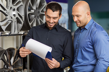 Image showing customer and salesman at car service or auto store