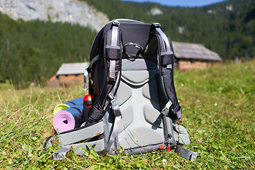 Image showing Backpack and yoga mats on mountain meadow.