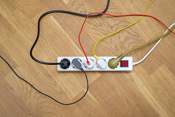 Image showing colorful plugs attached into extension cord