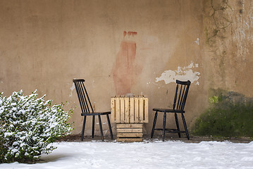 Image showing table and two chairs near the wall