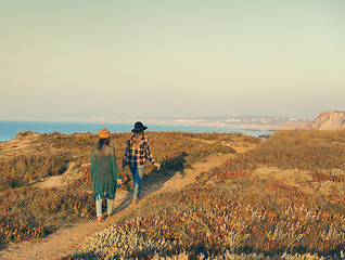 Image showing Girs walking ove the coastline