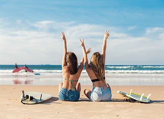 Image showing Two surfer girls at the beach