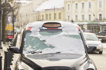 Image showing Black city taxi cab in snow