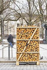 Image showing Pile of firewood stacked on the street