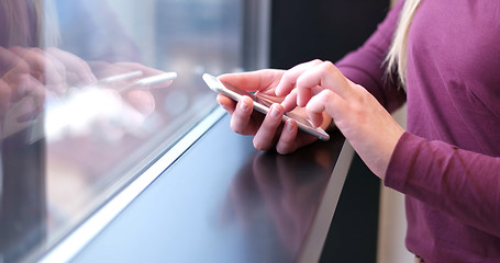 Image showing Close up of business woman using cell phone in office interior