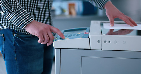 Image showing Male Assistant Using Copy Machine in modern office