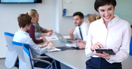 Image showing Portrait of  smiling casual businesswoman using tablet  with cow