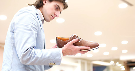 Image showing Man Chooses Shoes At Shoe Store