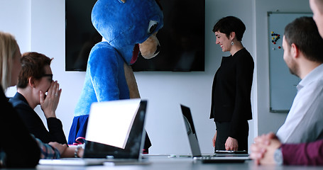 Image showing boss dresed as bear having fun with business people in trendy of