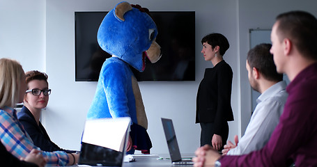 Image showing boss dresed as bear having fun with business people in trendy of