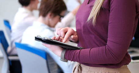 Image showing Pretty Businesswoman Using Tablet In Office Building during conf