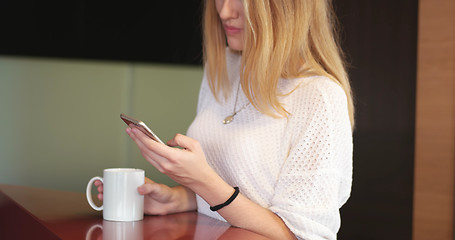 Image showing Blonde drinking coffee enjoying relaxing lifestyle