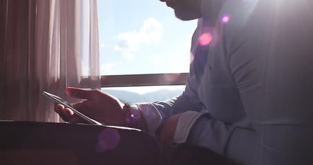 Image showing Business Man Talking On Cell Phone At Home