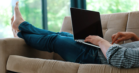 Image showing Man using laptop in living room