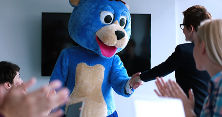 Image showing boss dresed as bear having fun with business people in trendy of