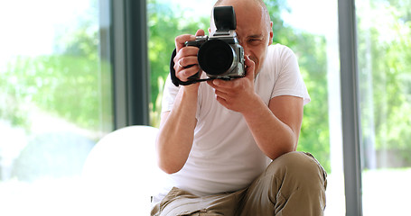 Image showing Photographer takes pictures with DSLR camera