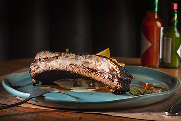 Image showing grilled pork ribs on dark plate