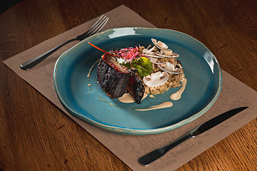 Image showing grilled pork ribs on dark plate