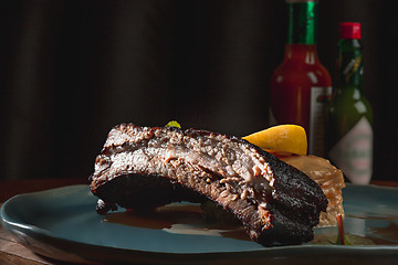 Image showing grilled pork ribs on dark plate