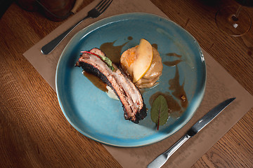 Image showing grilled pork ribs on dark plate