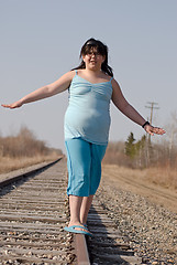Image showing Girl Balancing On Railroad Tracks