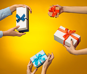 Image showing The closeup picture of man and woman\'s hands with gift box