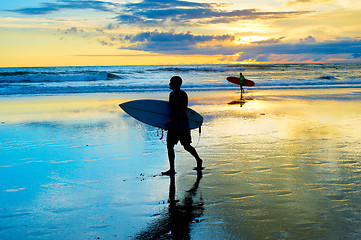 Image showing Surfers walking on the beach