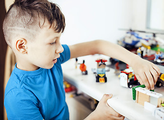 Image showing little cute preschooler boy playing toys at home happy smiling, lifestyle children concept