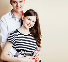 Image showing couple of happy smiling teenagers students, warm colors having a kiss, lifestyle people concept, boy and girl together 