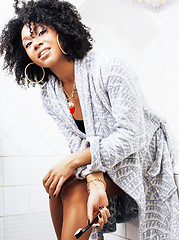 Image showing beauty young african american woman in bathrobe with tooth brush